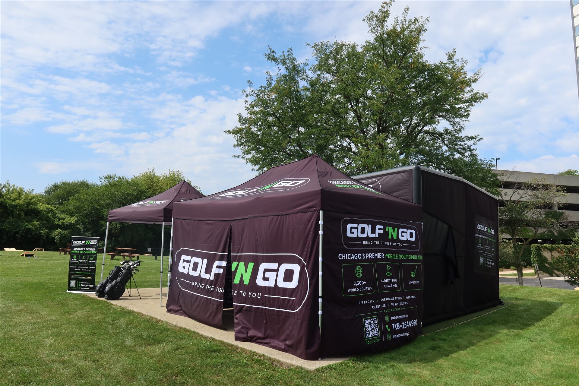 Golf 'N Go mobile golf simulator tent setup at an outdoor Chicagoland office event