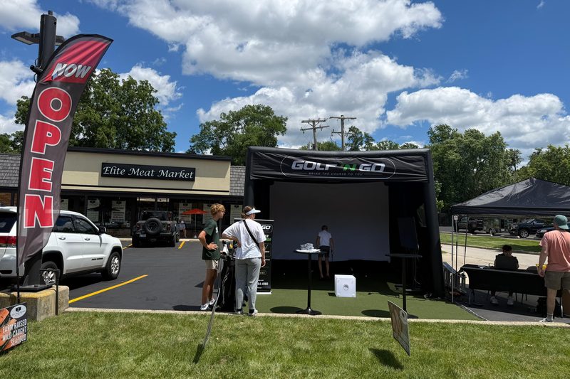 Golf 'n Go mobile golf simulator set up at a Chicagoland event — play Bethpage Black in Naperville
