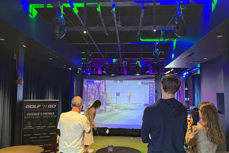 Golf 'n Go mobile golf simulator set up at a Chicagoland event — play Oakmont in Naperville