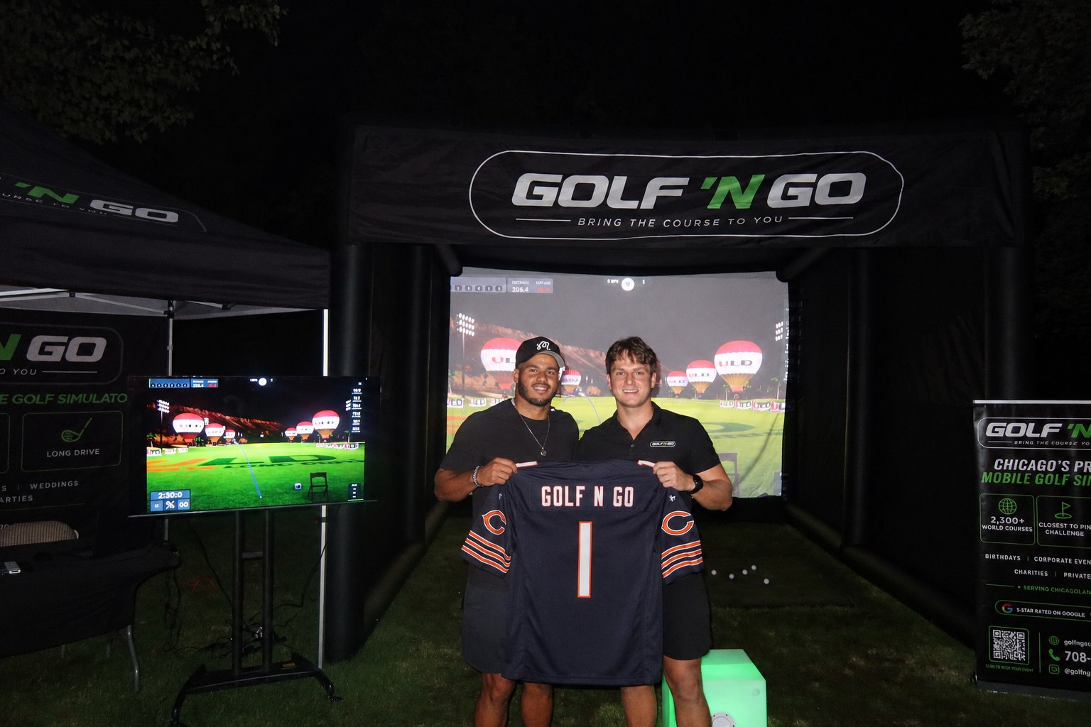 T.J. Edwards, Chicago Bears linebacker, with Jake in front of the Golf 'N Go simulator holding a Golf 'N Go Bears jersey